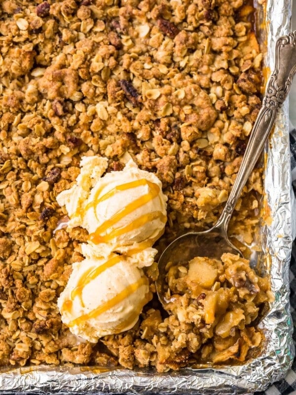 apple crisp in a sheet pan topped with ice cream