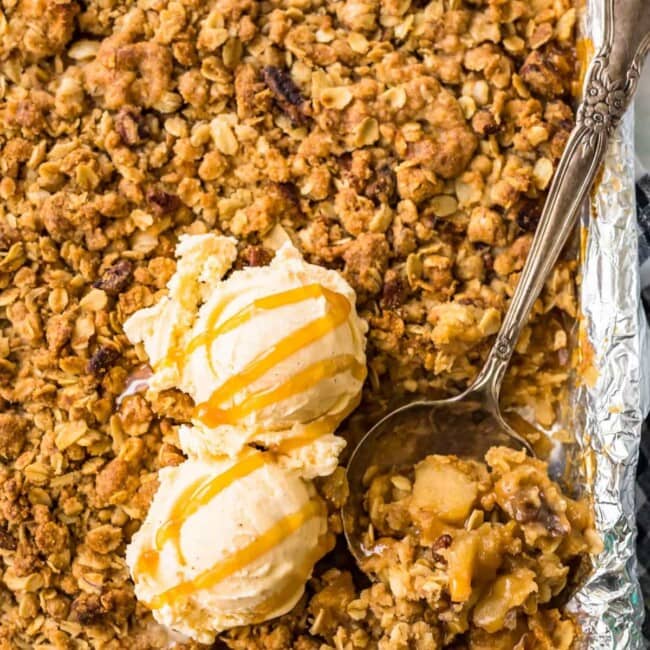 apple crisp in a sheet pan topped with ice cream