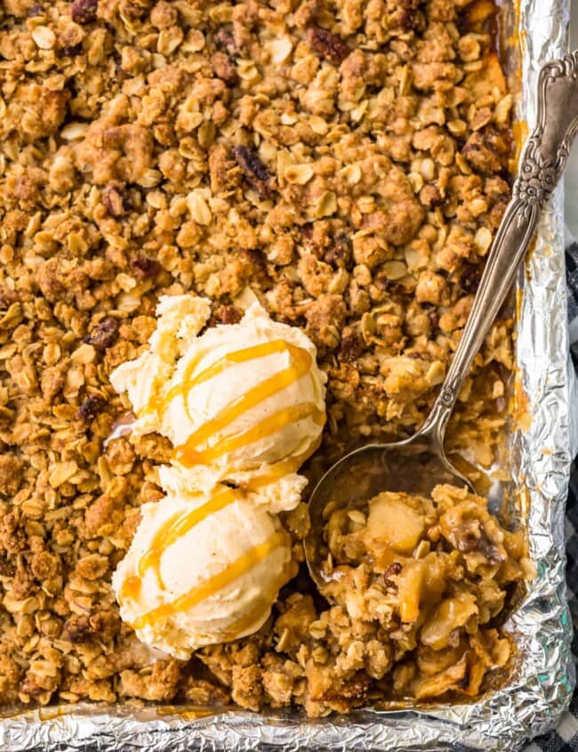 apple crisp in a sheet pan topped with ice cream