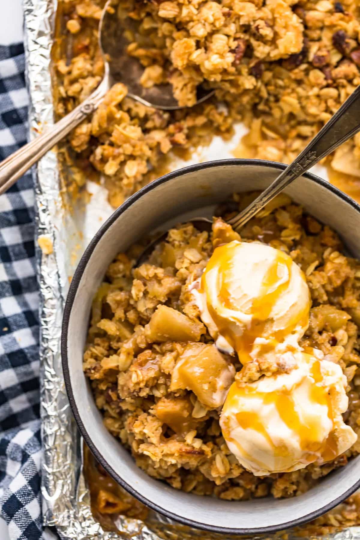Apple crisp served in a bowl with ice cream