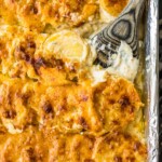 sheet pan scalloped potatoes in a pan with spoon