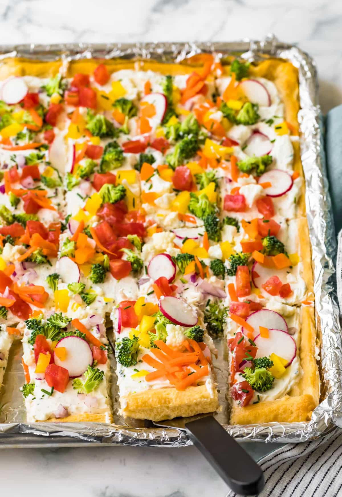 Veggie pizza cut into squares