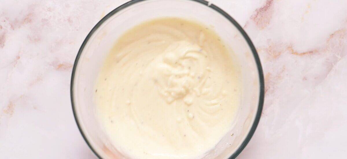 The ingredients for the salad dressing in a glass bowl.