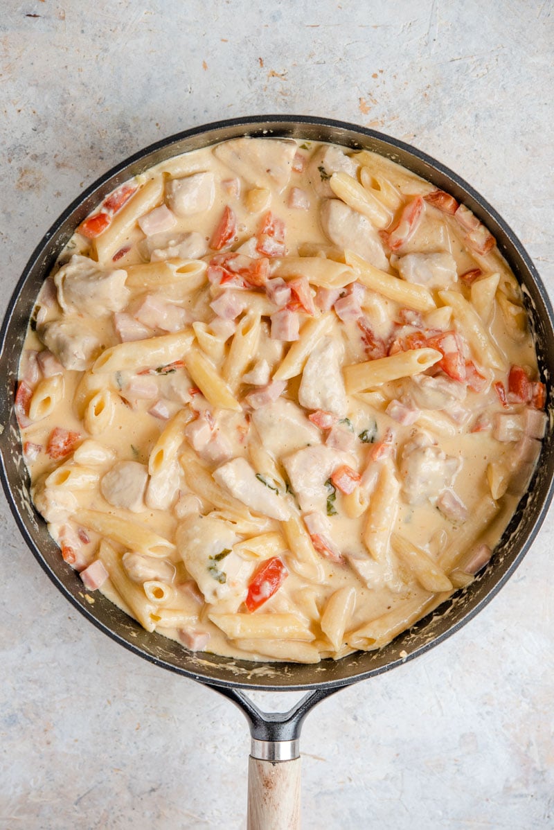 One-Pot Chicken Alfredo with Feta is a creamy, decadent dish that tastes fancy but is super simple and versatile. Your family will love this one pot classic! An overhead shot of One-Pot Chicken Alfredo