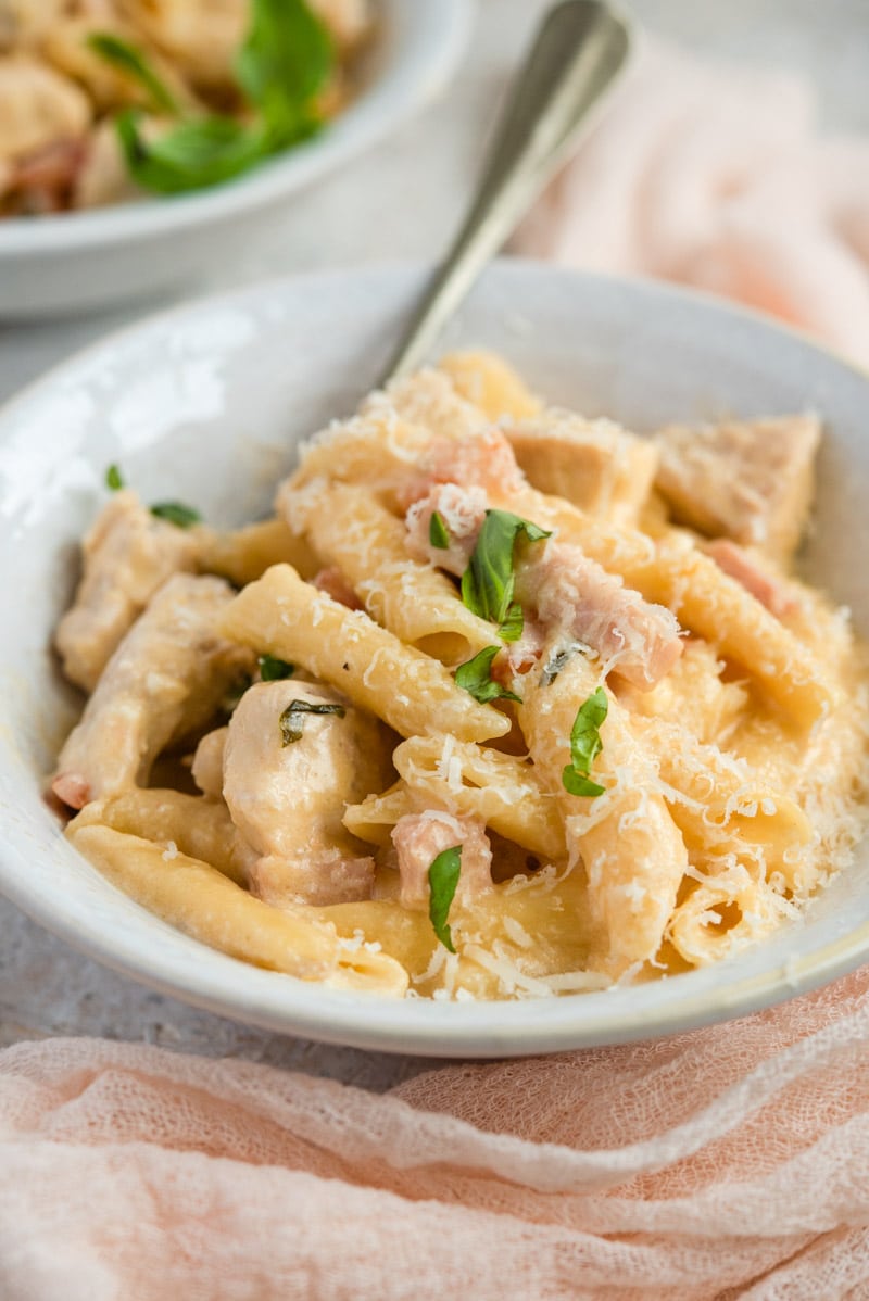 A close up of chicken alfredo in a serving bowl