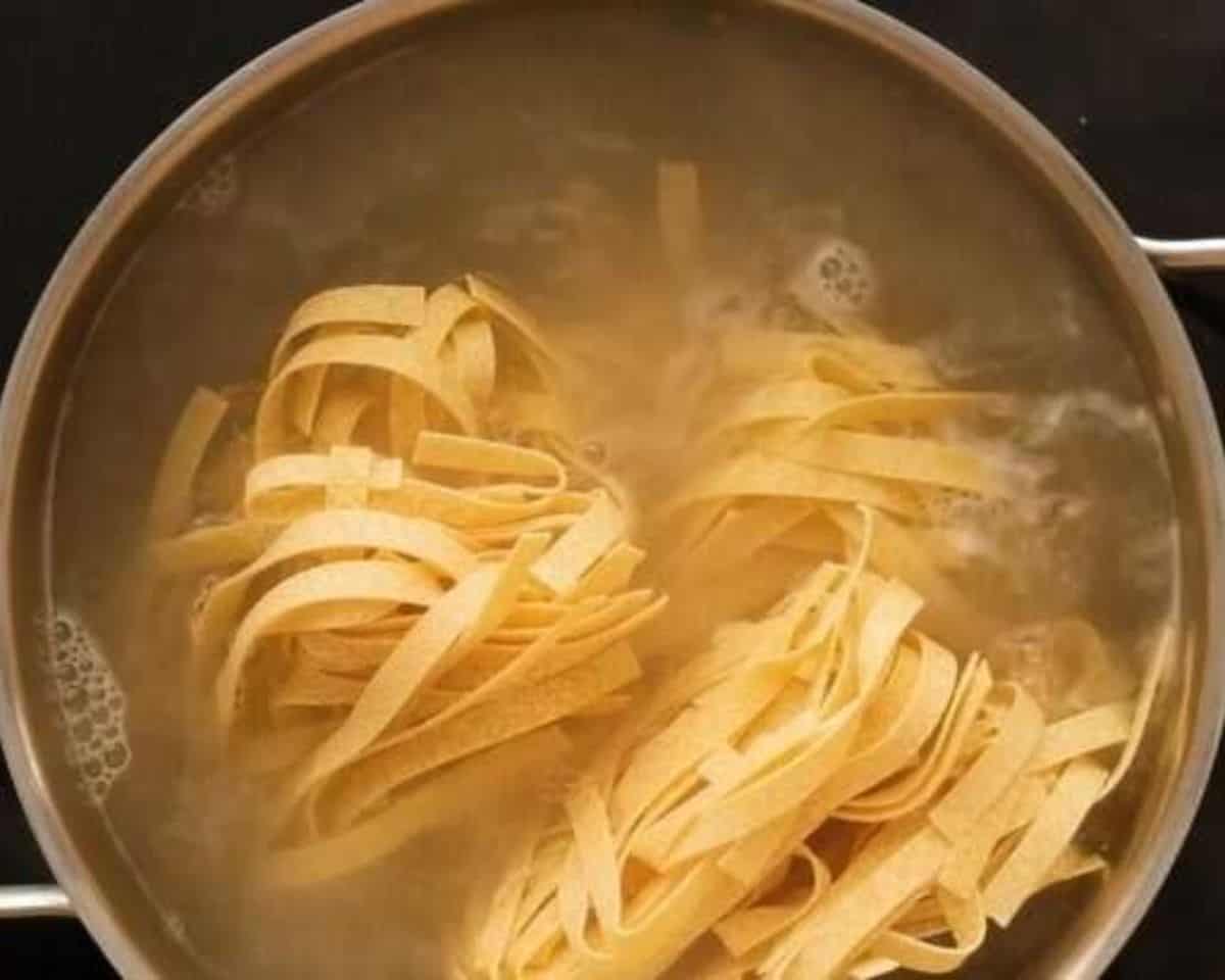 Boiling the pasta in a pot of water.  - 6