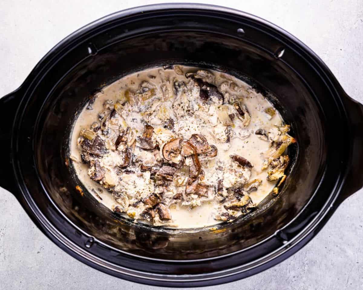 Ingredients to make chicken tetrazzini in a black crockpot.  - 15