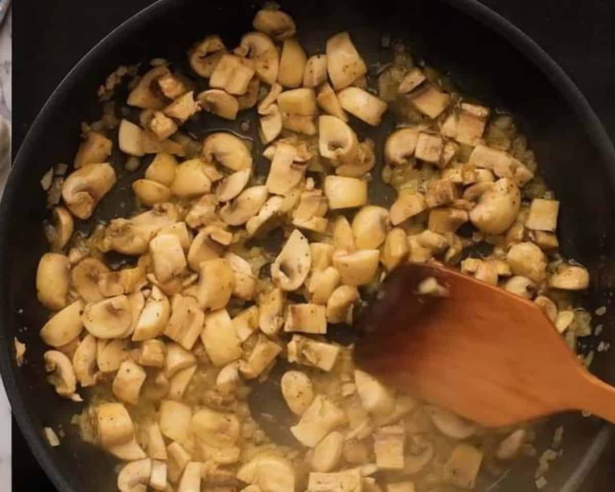 Sautéing mushrooms in a skillet with onions.  - 7