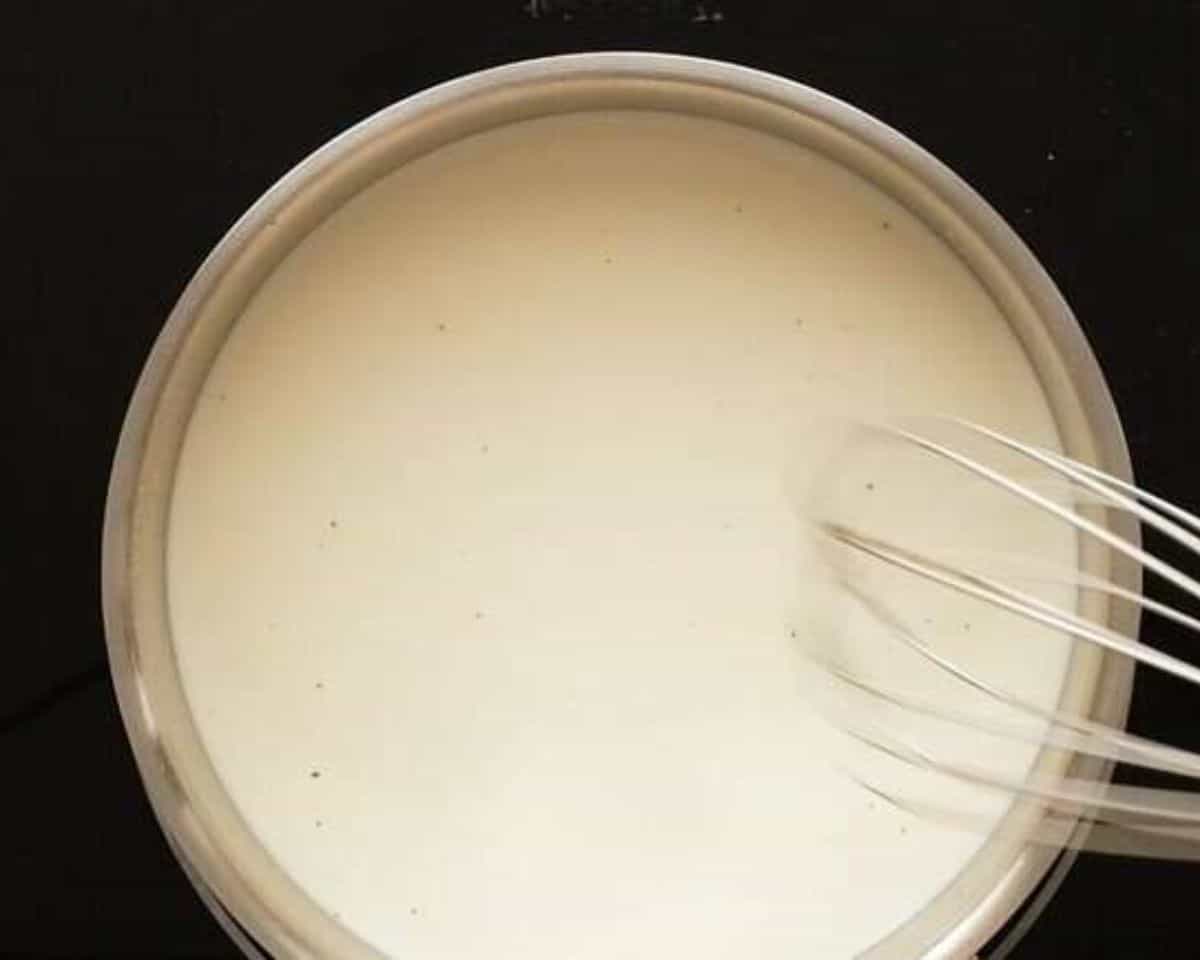 Simmering milk, cream and broth and stirring with a whisk. - 9