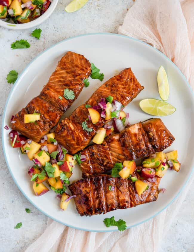 A plate of food on a table, with Salmon and Salsa