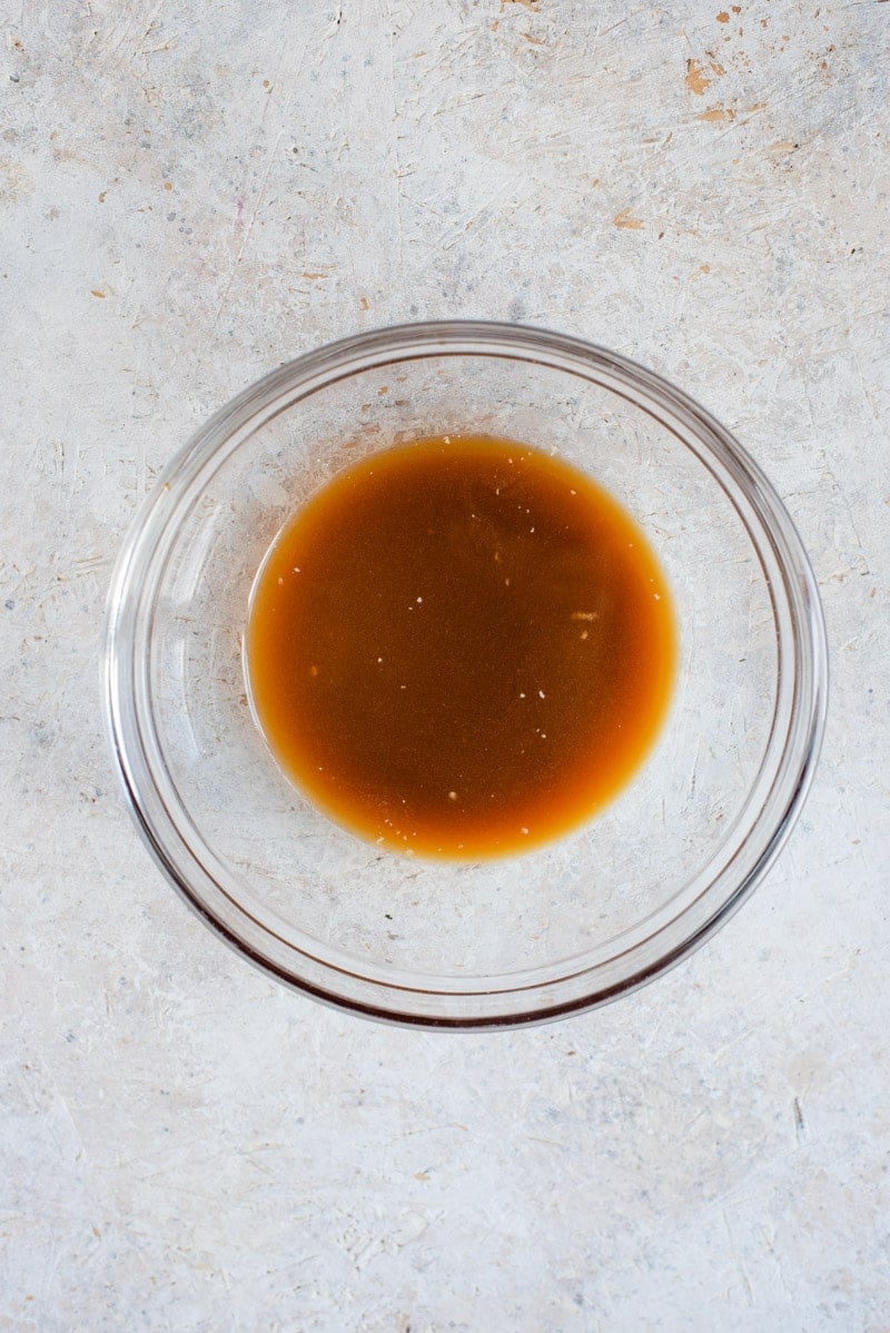 A small bowl of soy marinade for making grilled salmon fillet