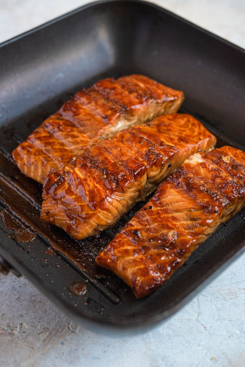 Grilled salmon fillets cooking on a grill