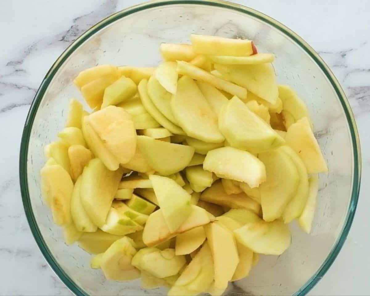 Apple slices in a glass bowl.
