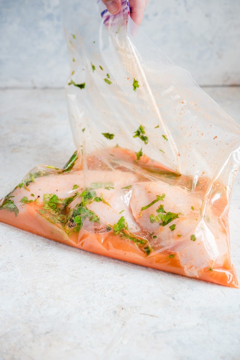 Marinating Tequila Lime Chicken in a plastic bag.