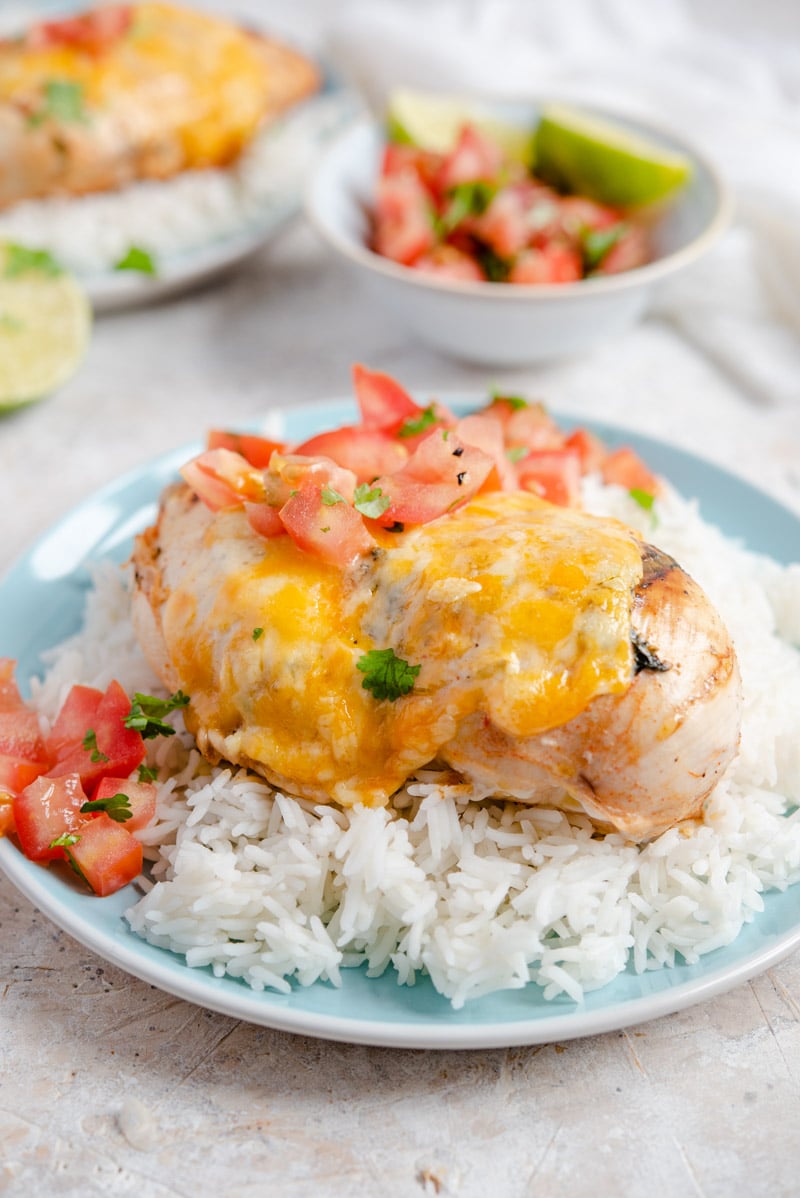 Grilled Tequila Lime Chicken on a plate with rice and salsa.