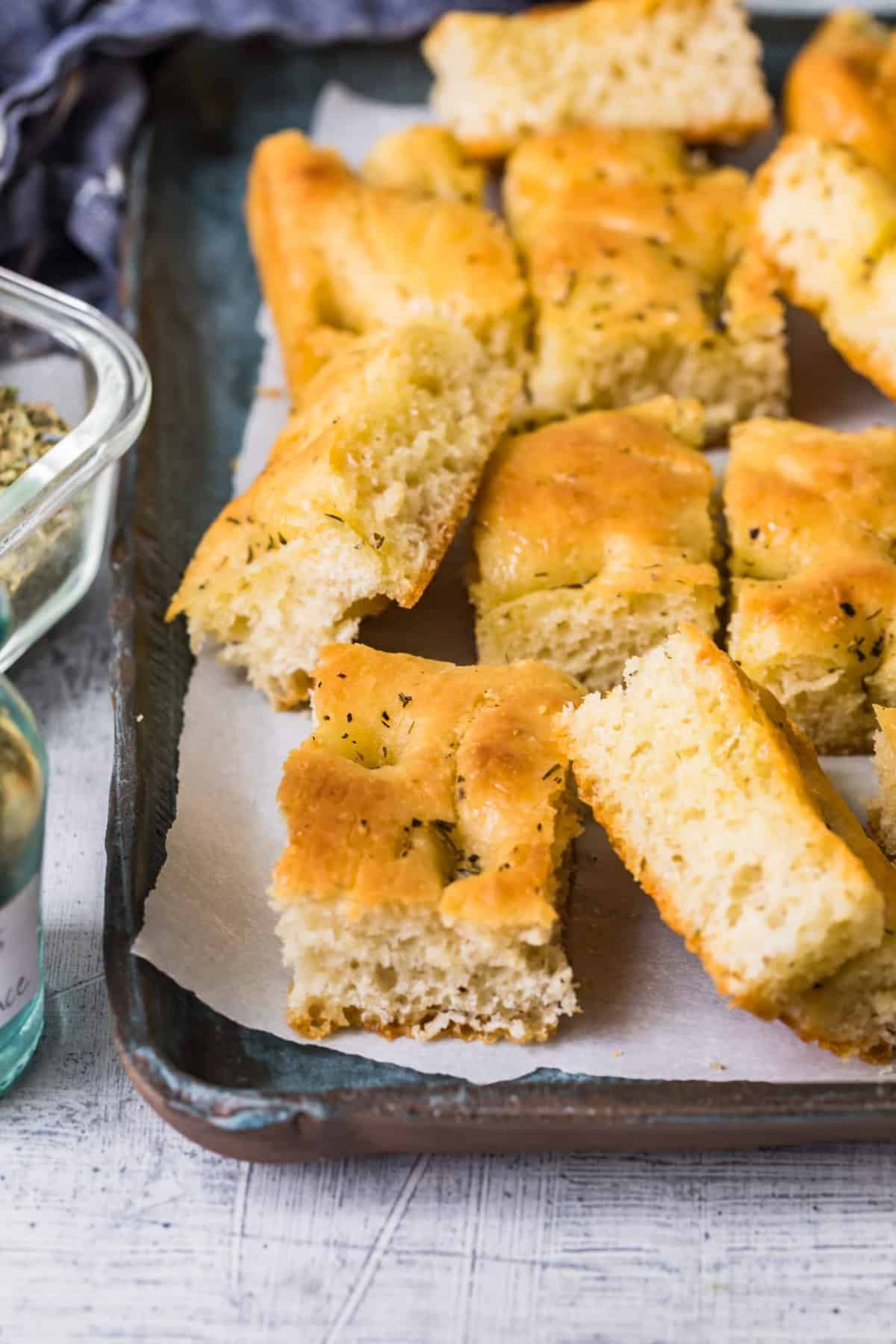 Pieces of focaccia bread on a baking sheet