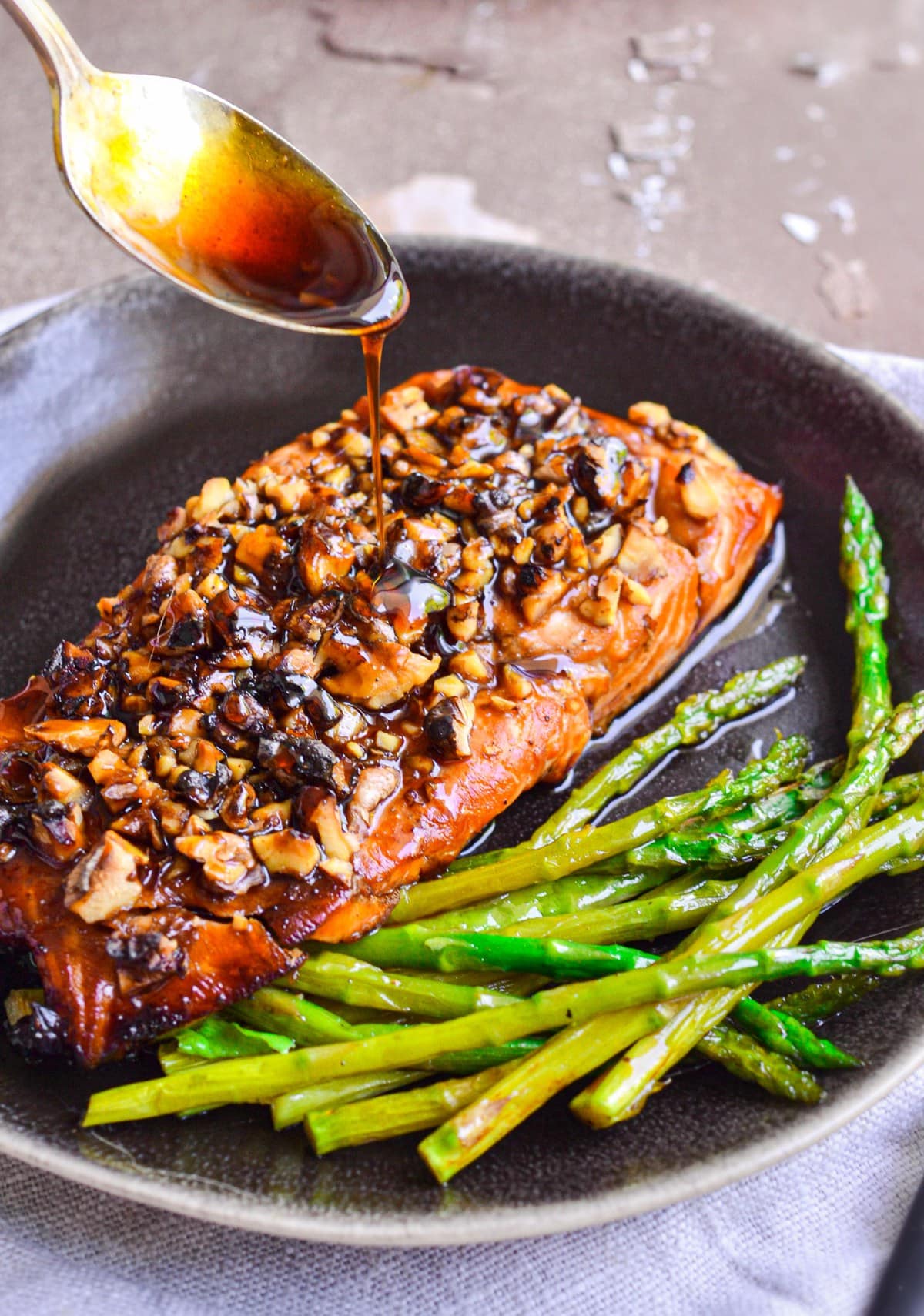 Brown Sugar Salmon being with bourbon glaze being poured with spoon