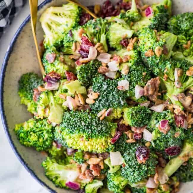 broccoli salad with bacon in a bowl and tongs