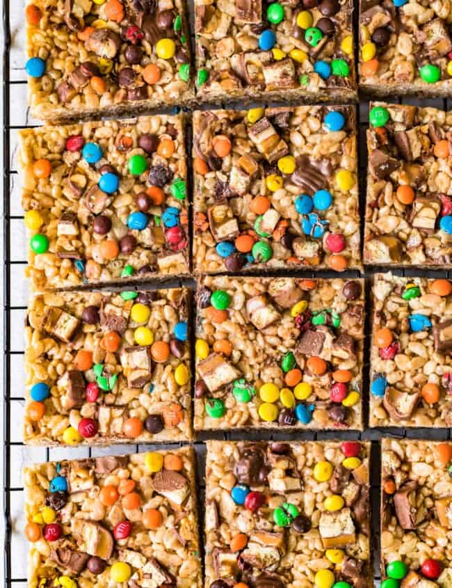 candy bar rice crispy treats cut into squares on cooling rack