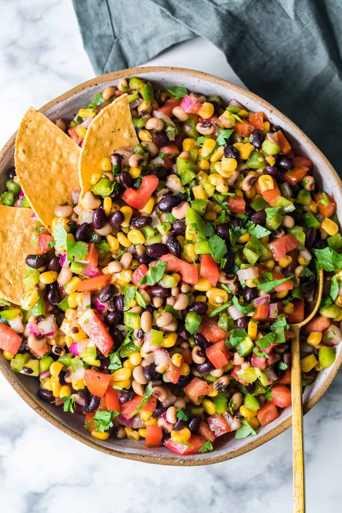 Cowboy caviar served with tortillas in a large bowl