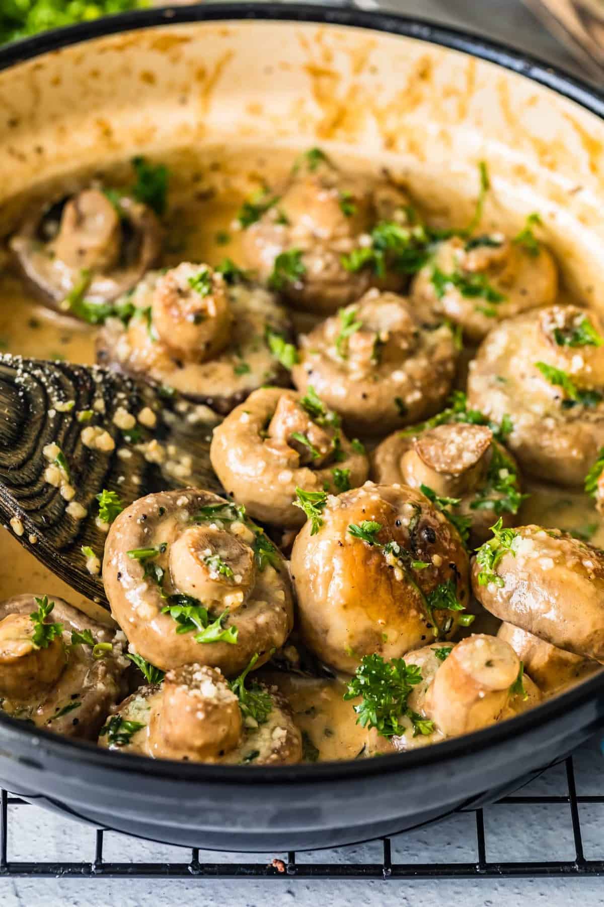Creamy garlic mushrooms cooking in a skillet