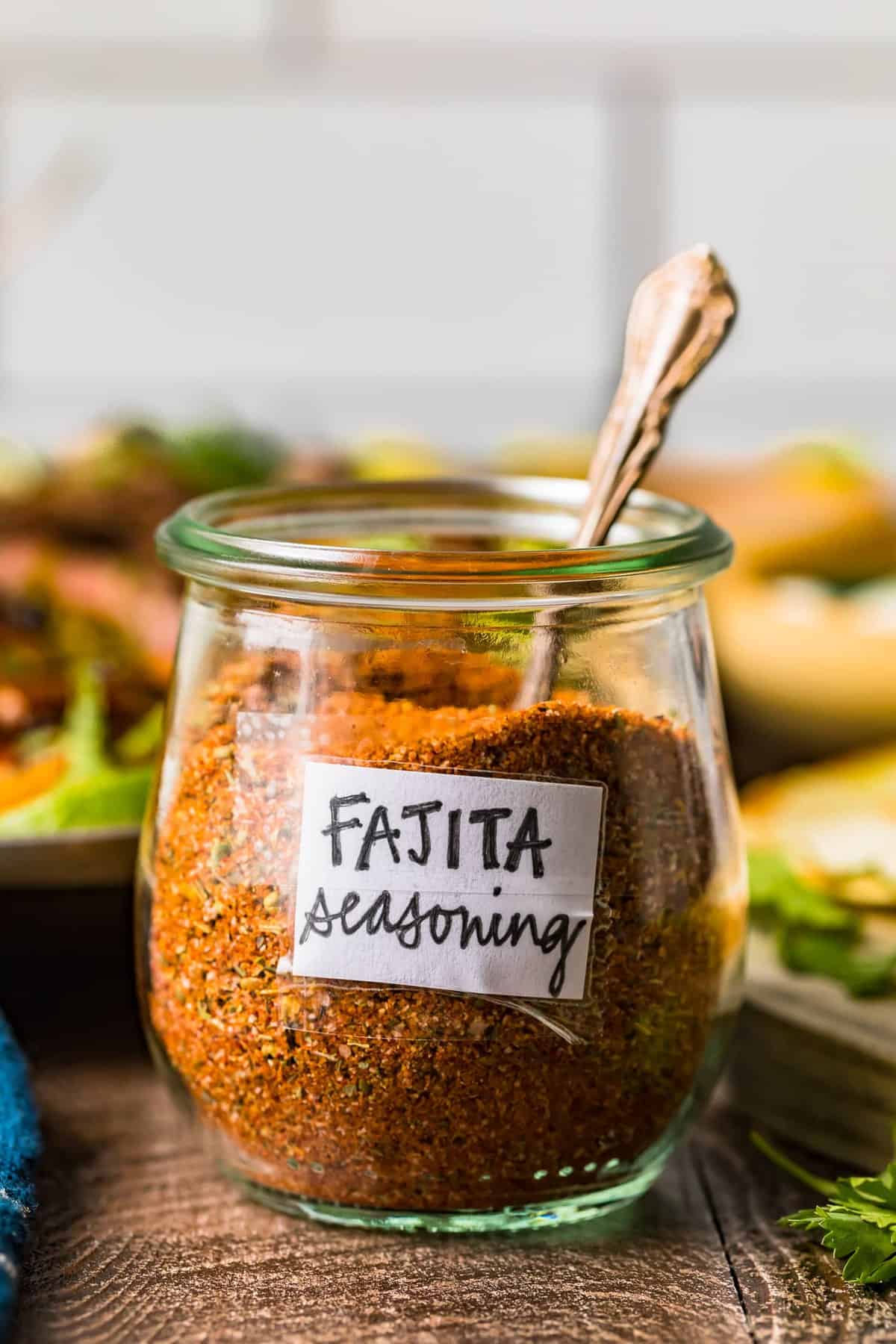 A spoon in a glass jar of fajita seasoning