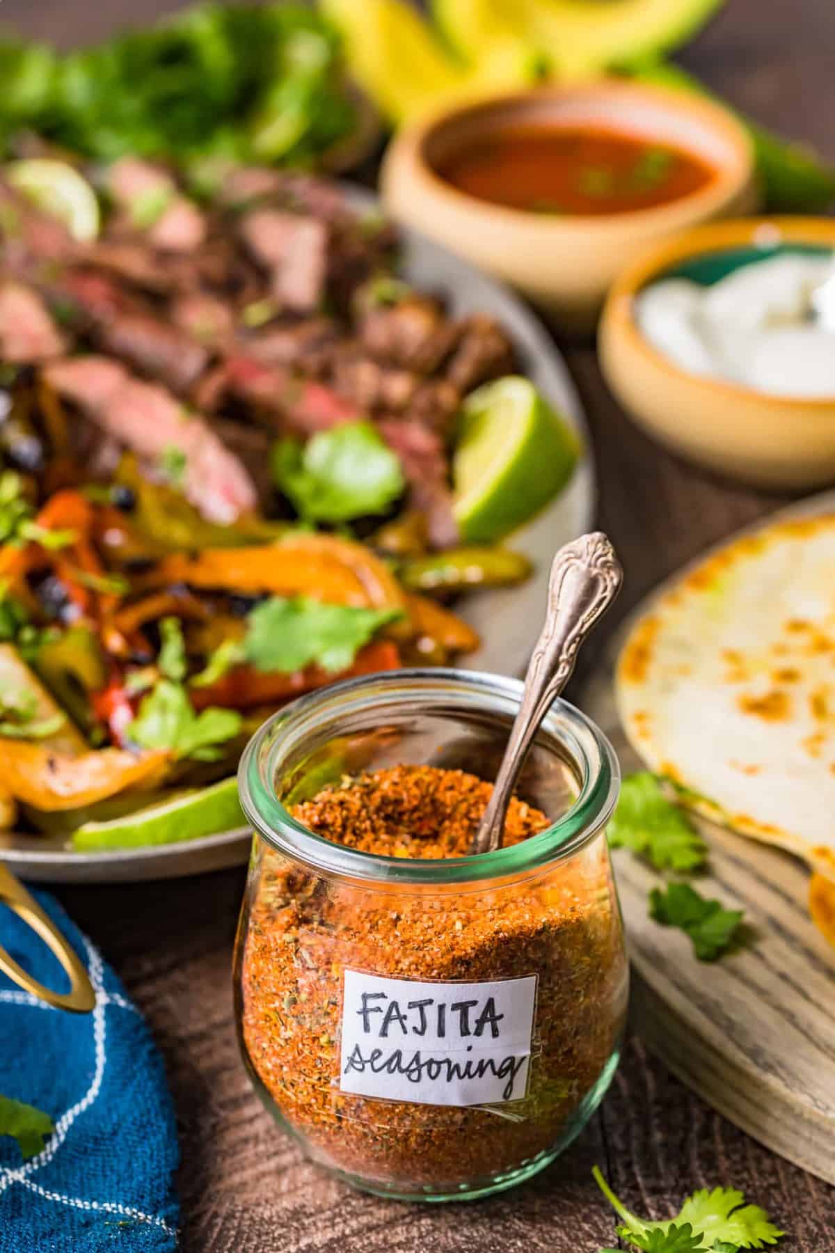A jar of fajita seasoning next to grilled steak