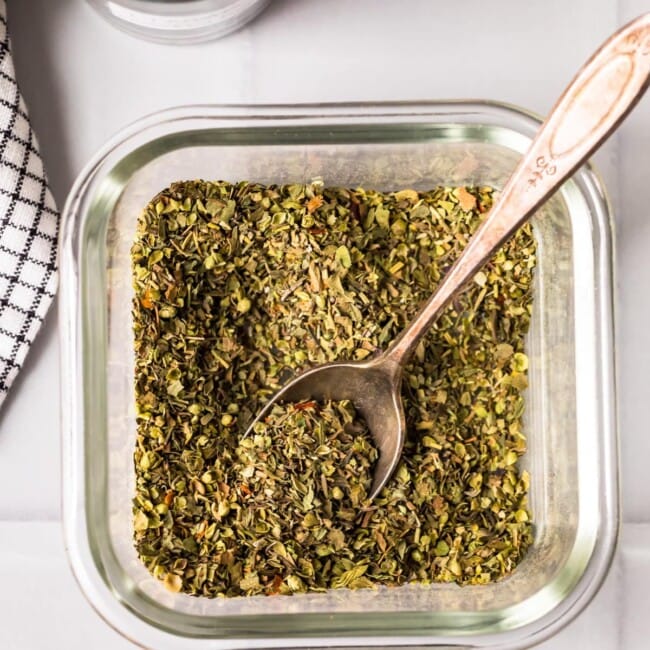 homemade italian seasoning in a jar with spoon