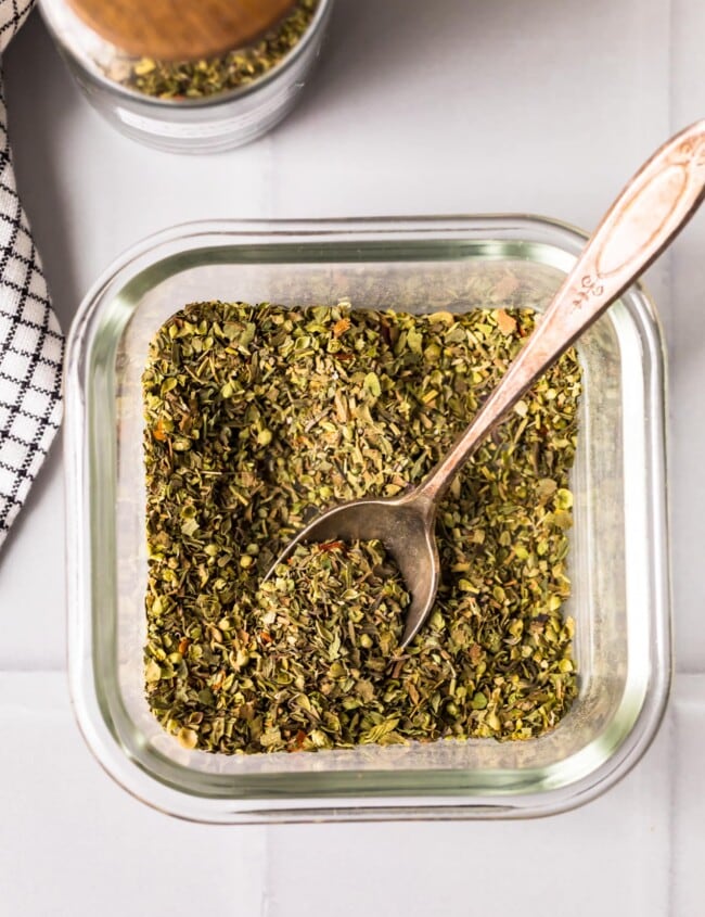 homemade italian seasoning in a jar with spoon