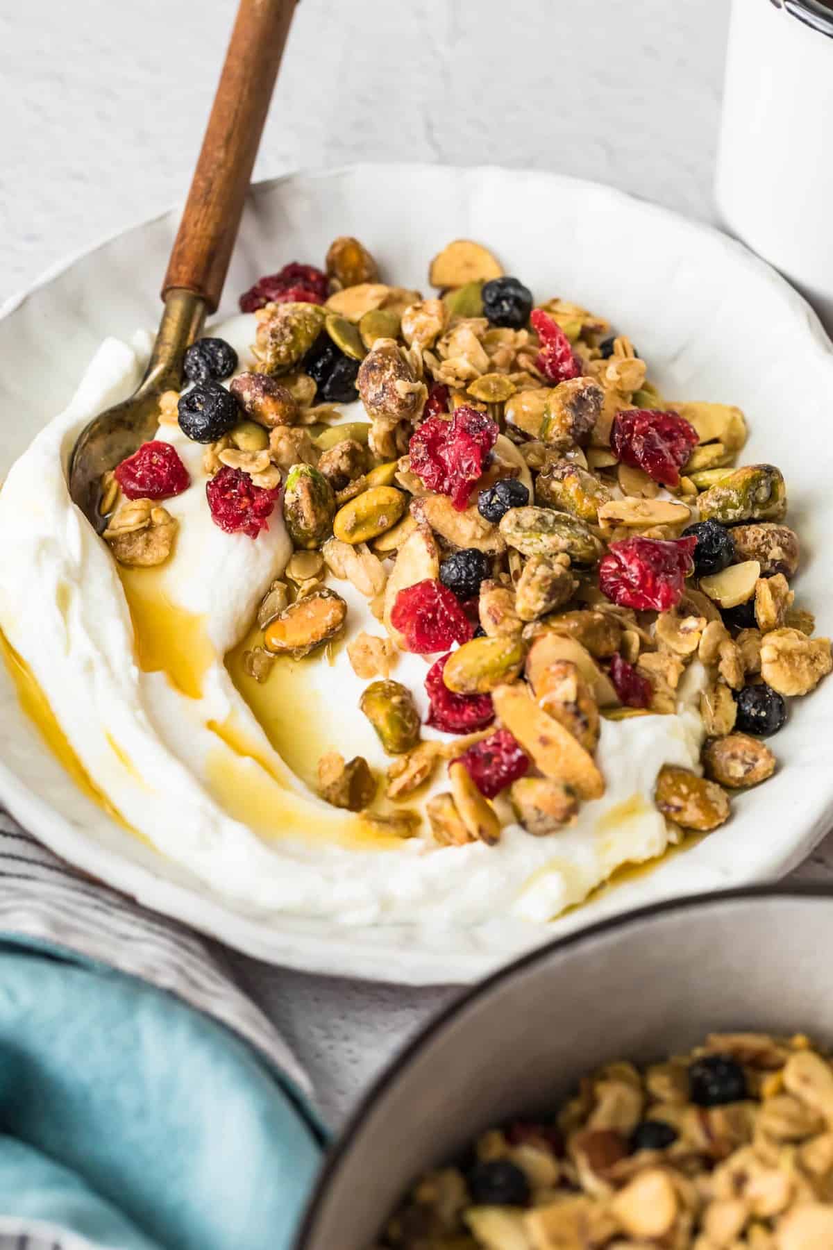 Maple Syrup Granola served with yogurt in a bowl with a spoon