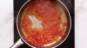 tomatoes simmering in a pan.