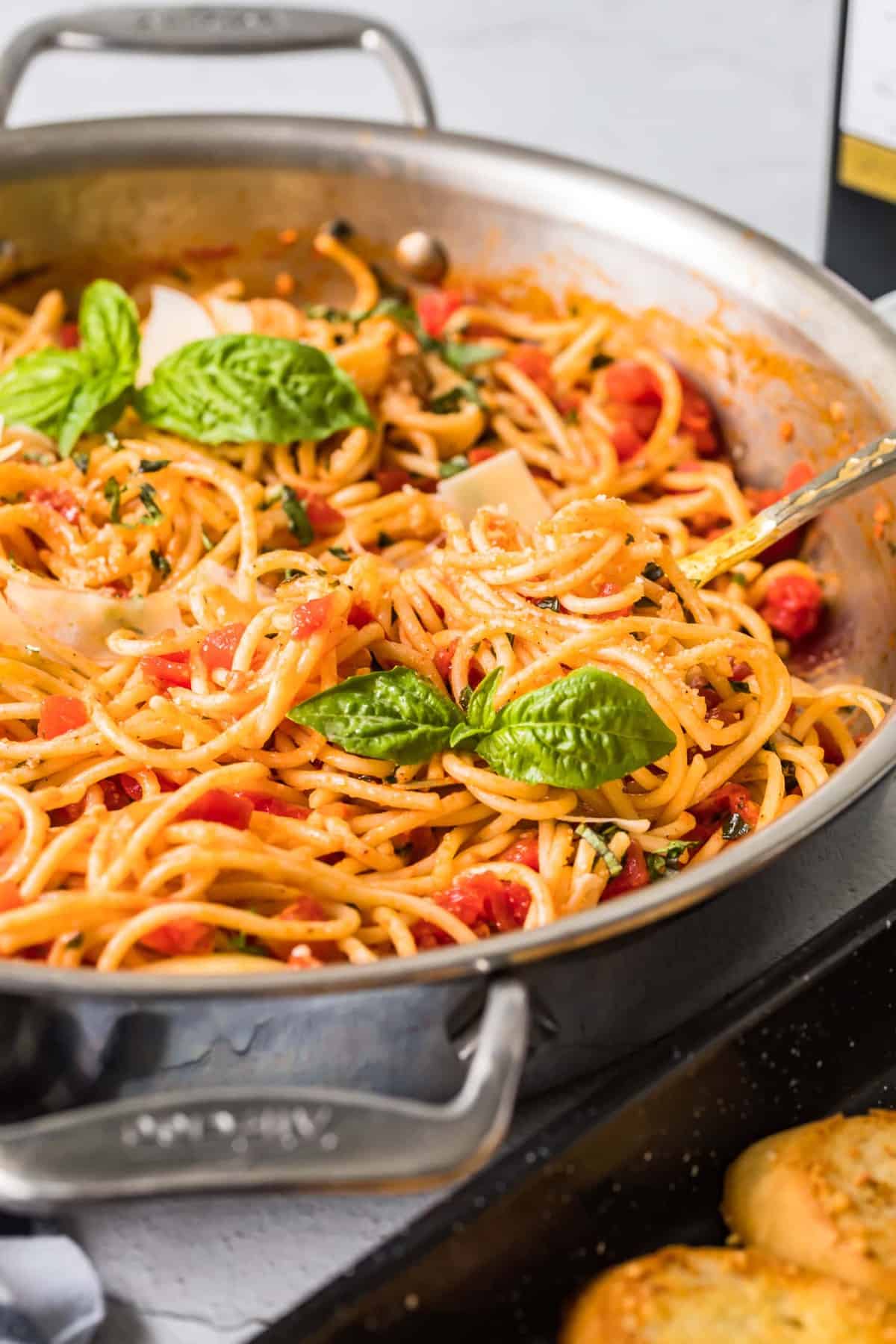 A pan with spaghetti and red sauce