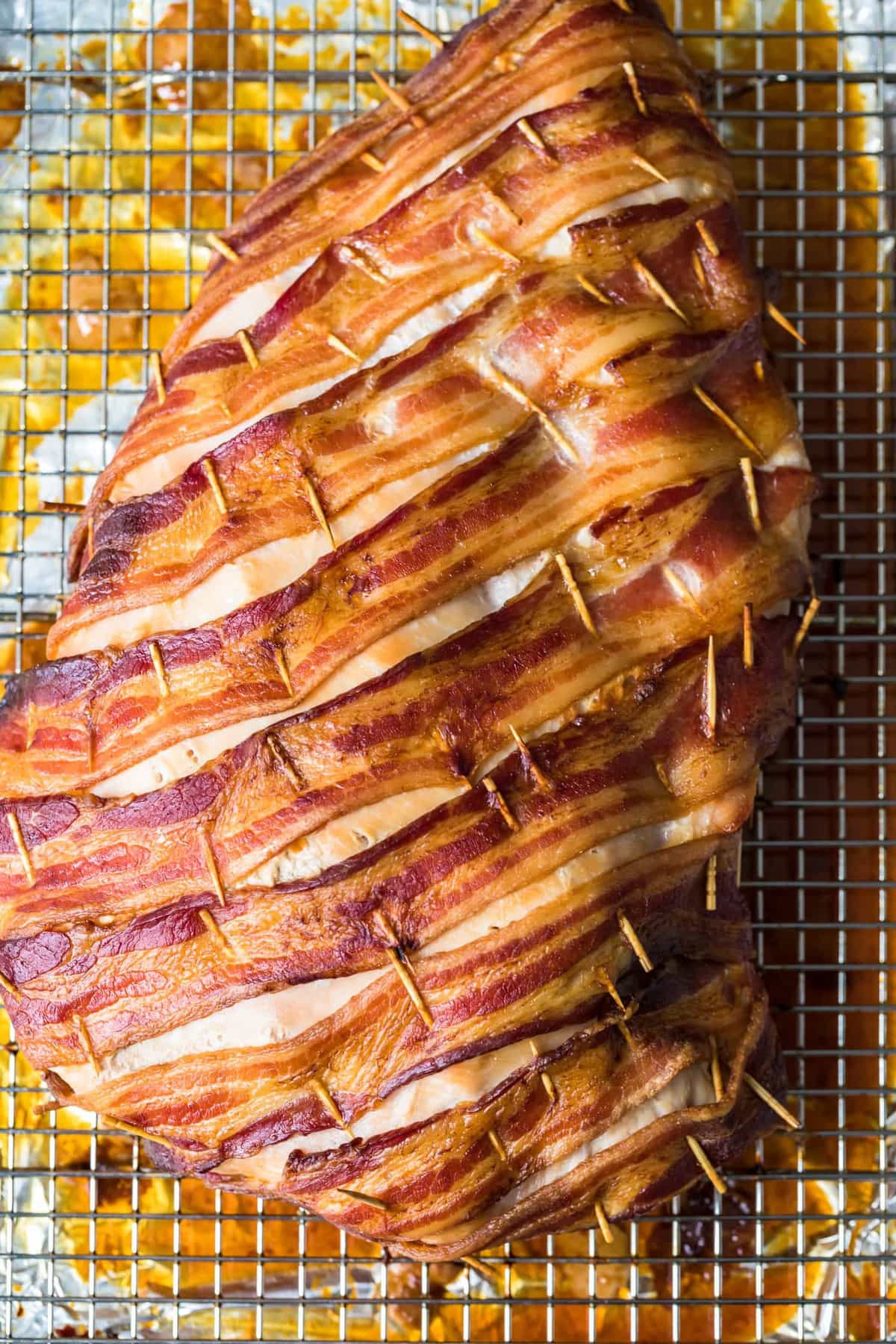 The bacon wrapped turkey breast on a cooling rack