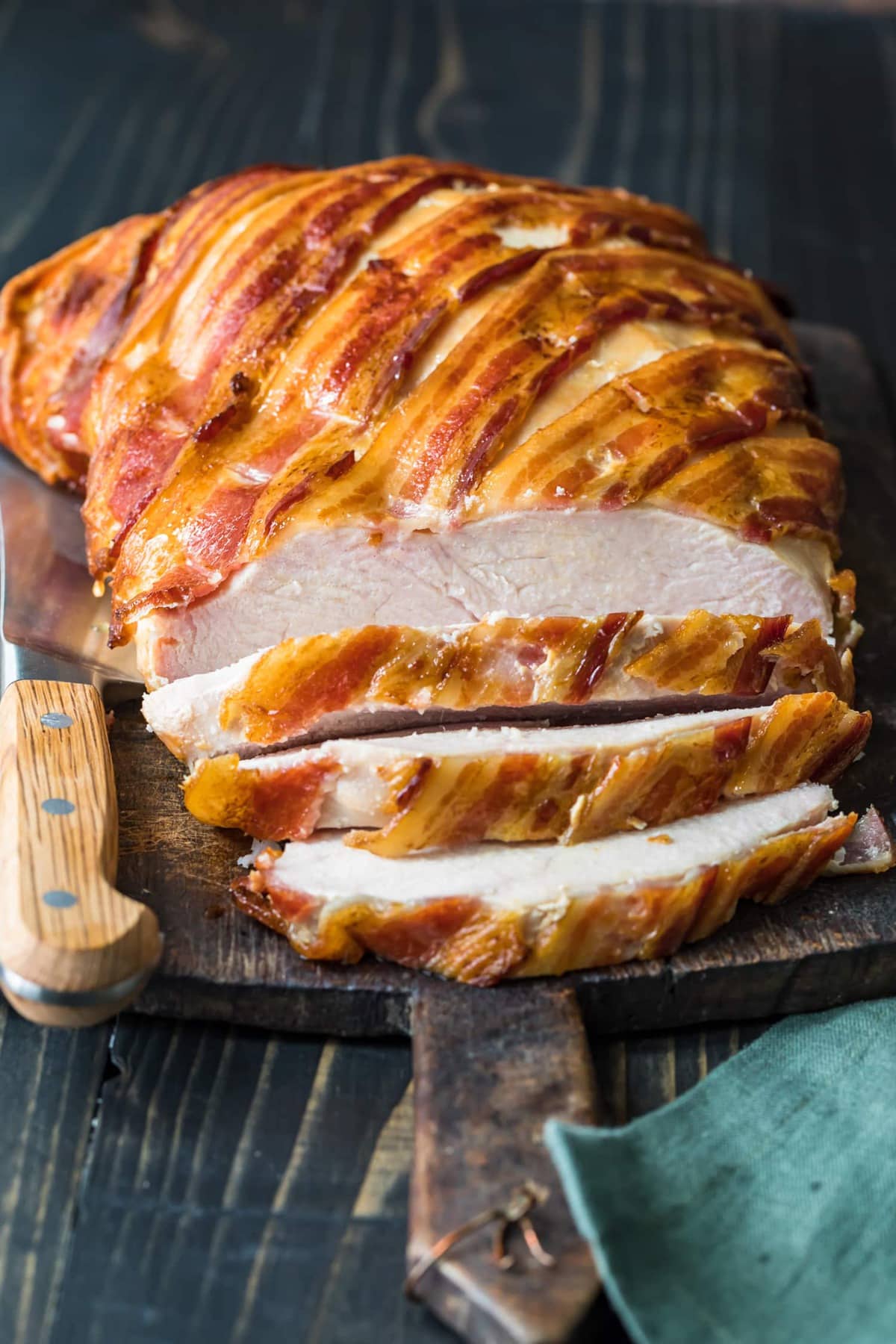 Bacon wrapped turkey breast being sliced
