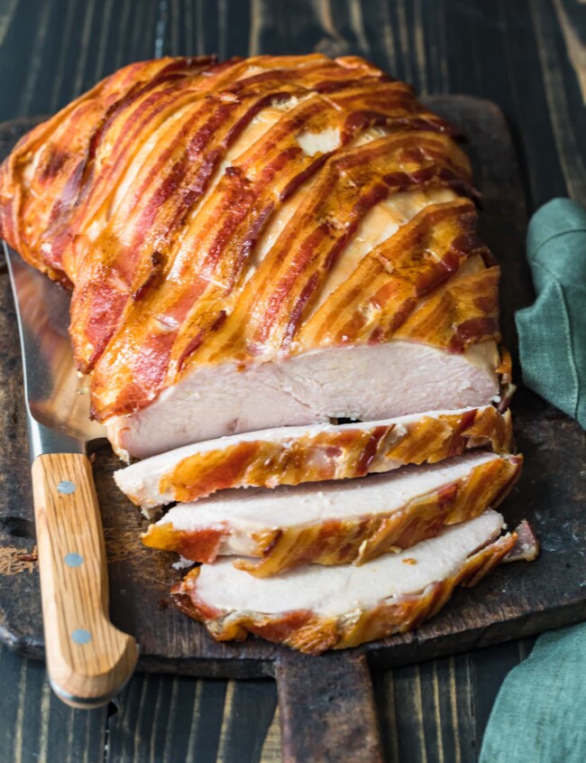 bacon wrapped turkey breast on cutting board