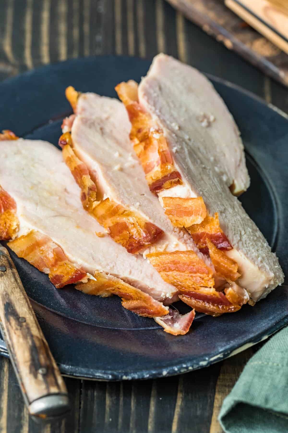 Close up of slices of turkey on a black plate