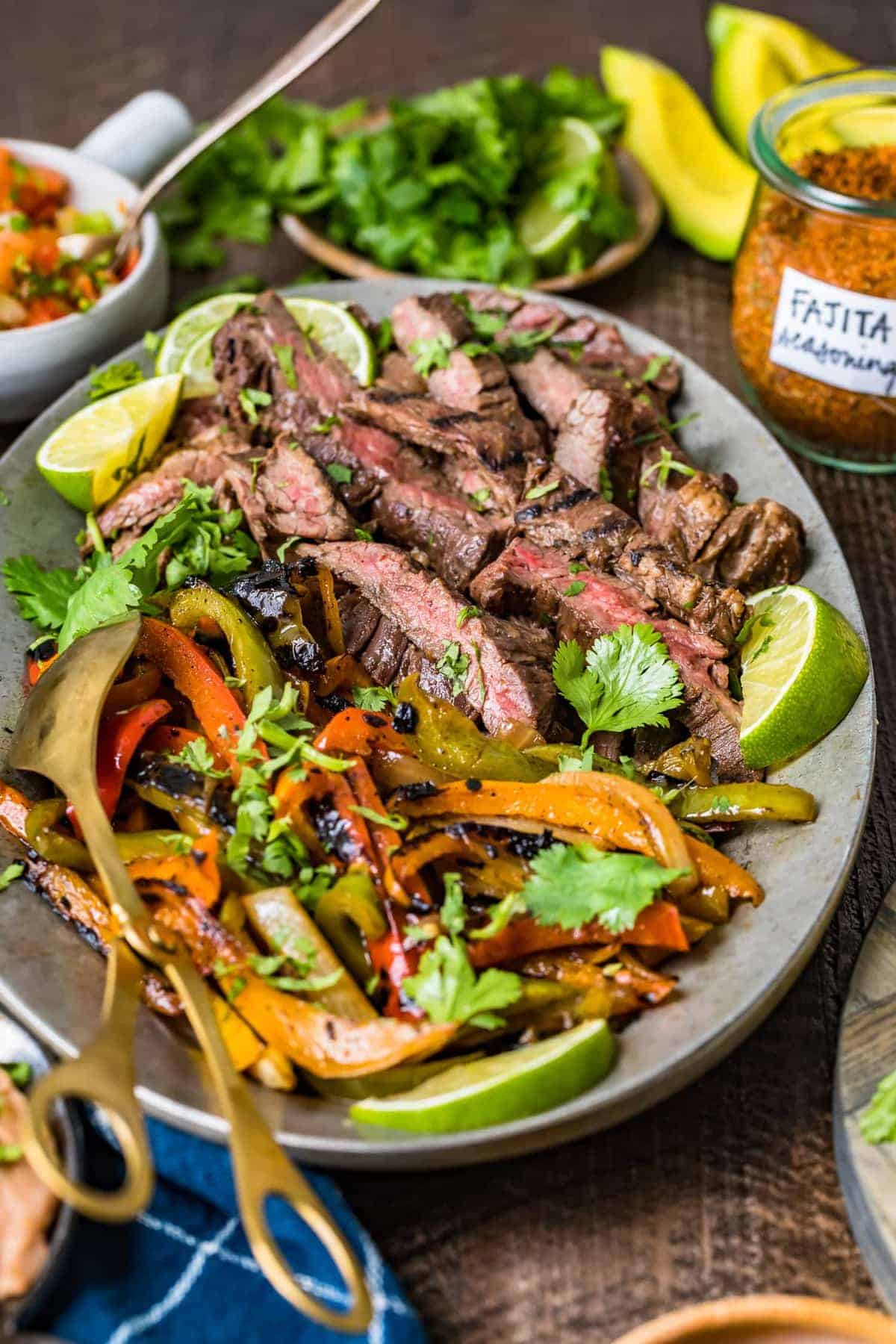 Close up of strips of grilled steak and vegetables