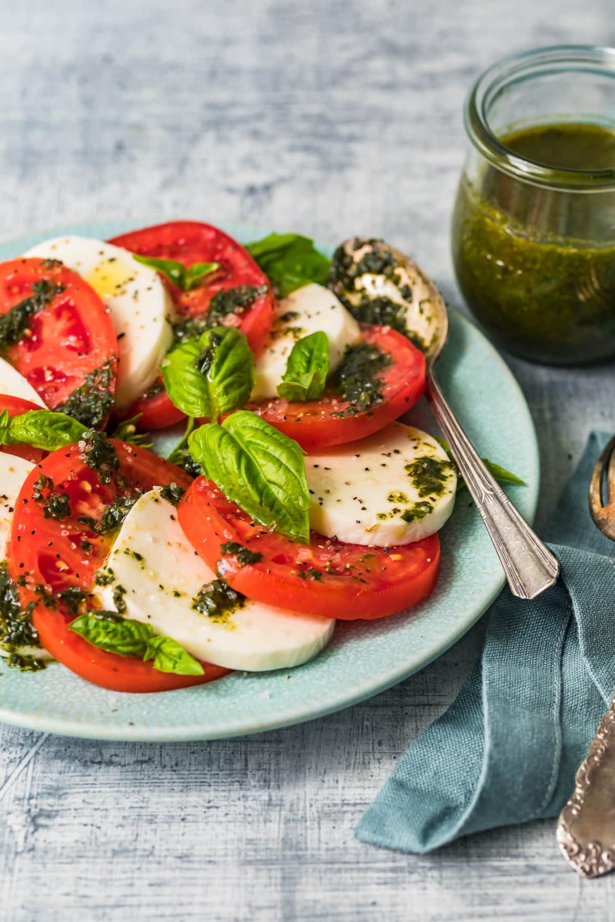 Tomato and mozzarella salad with basil dressing on top