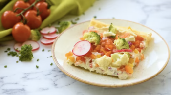 a slice of veggie pizza on a white plate.