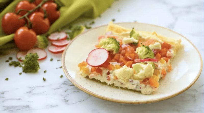 a slice of veggie pizza on a white plate.