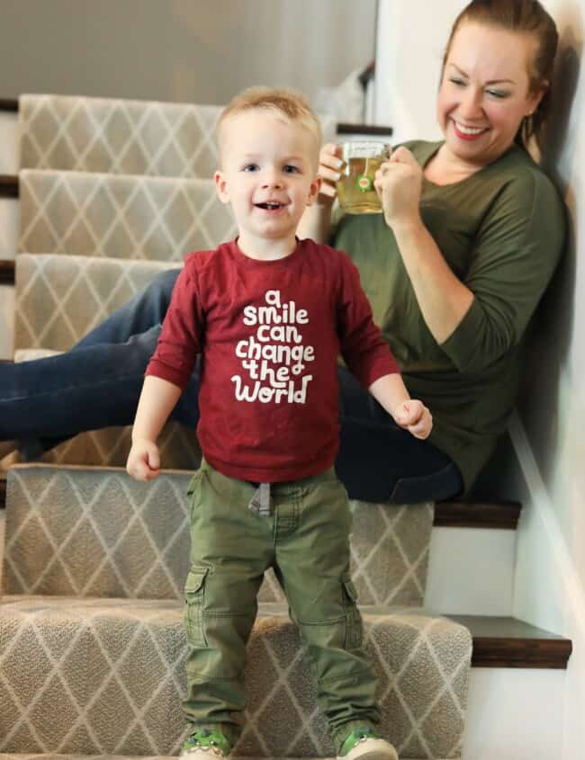 little boy smiling on stairs