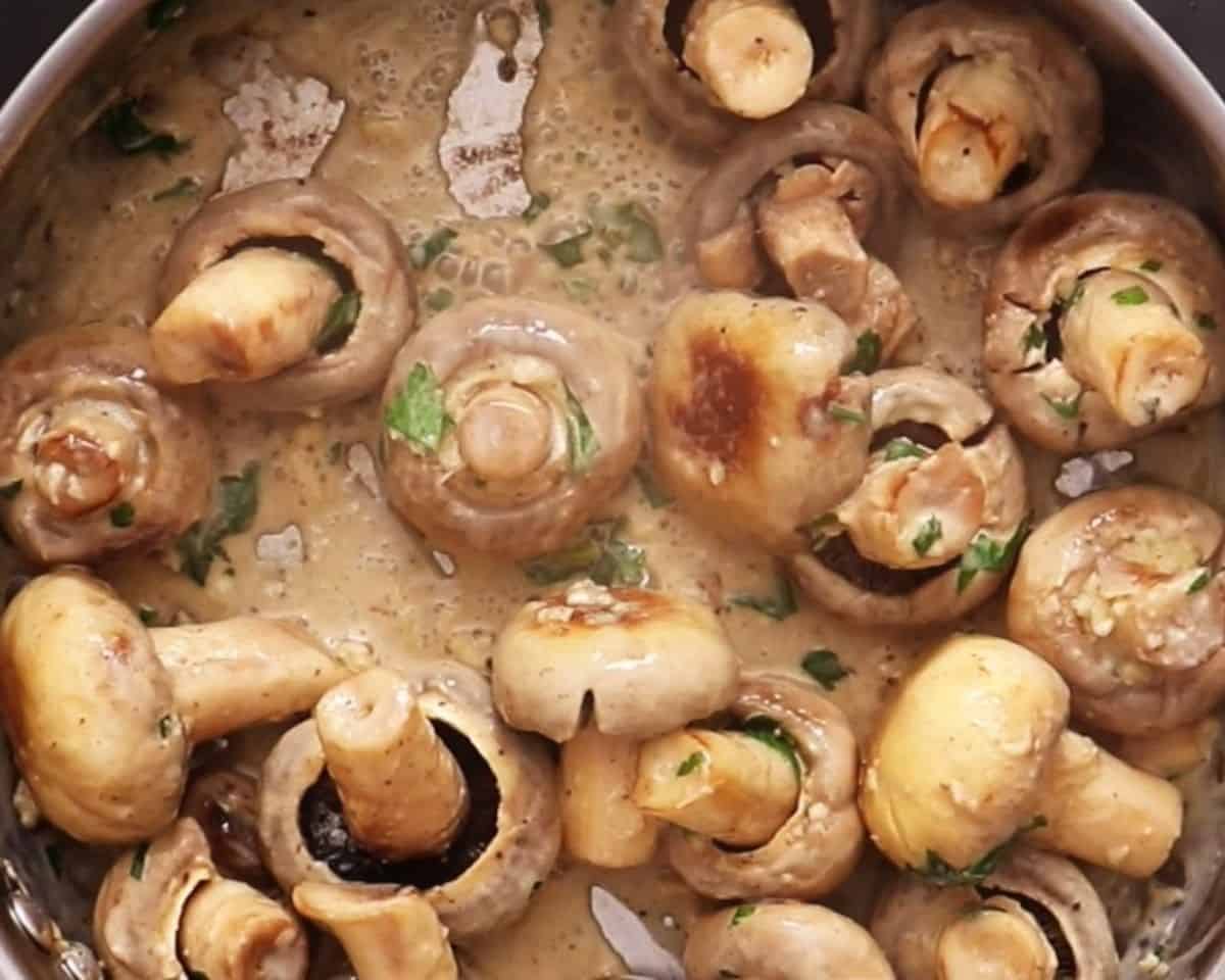 Mushrooms simmering in a cream sauce.