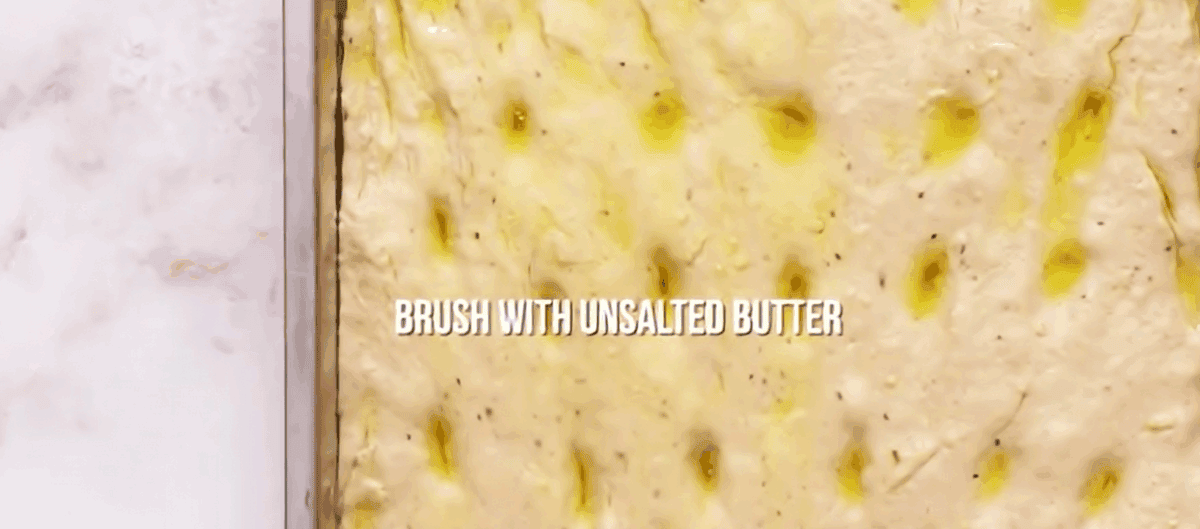 Focaccia dough brushed with butter.
