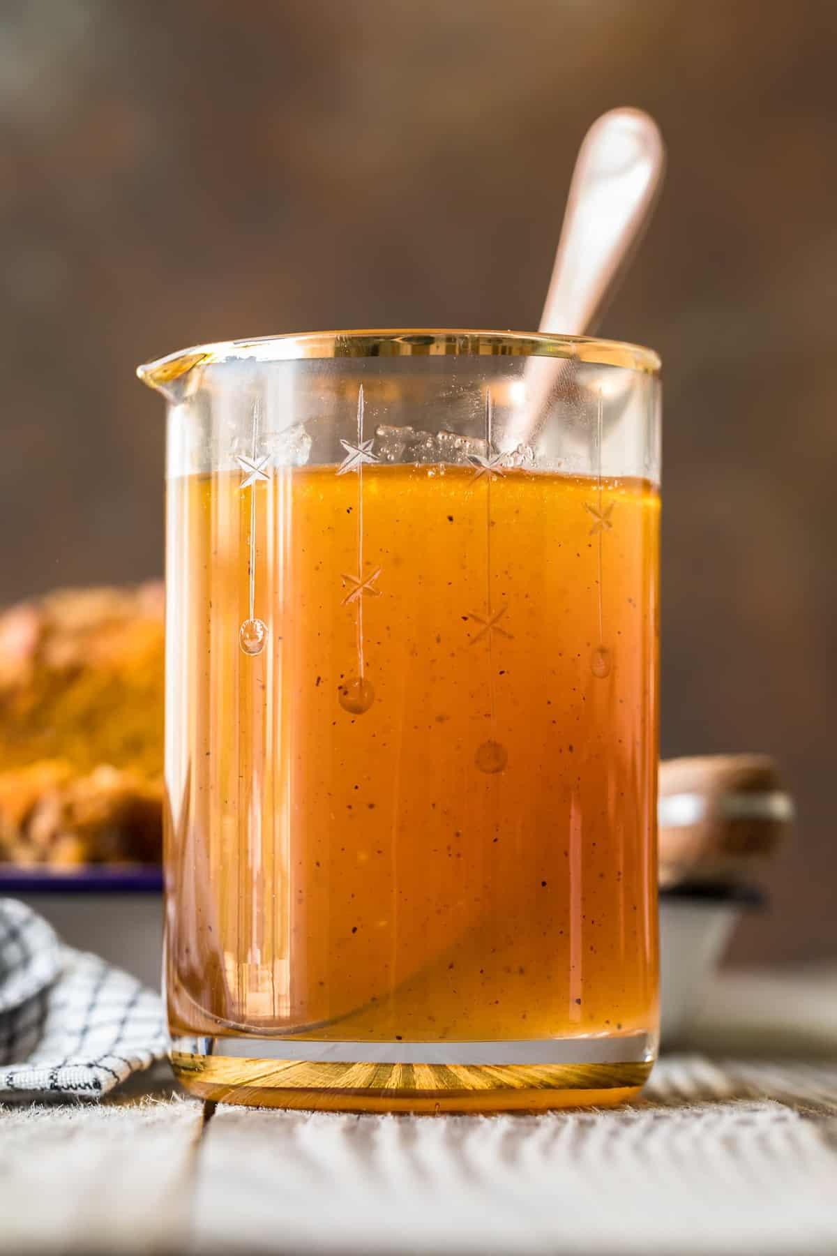 Apple Cider Sauce in a jug with a spoon