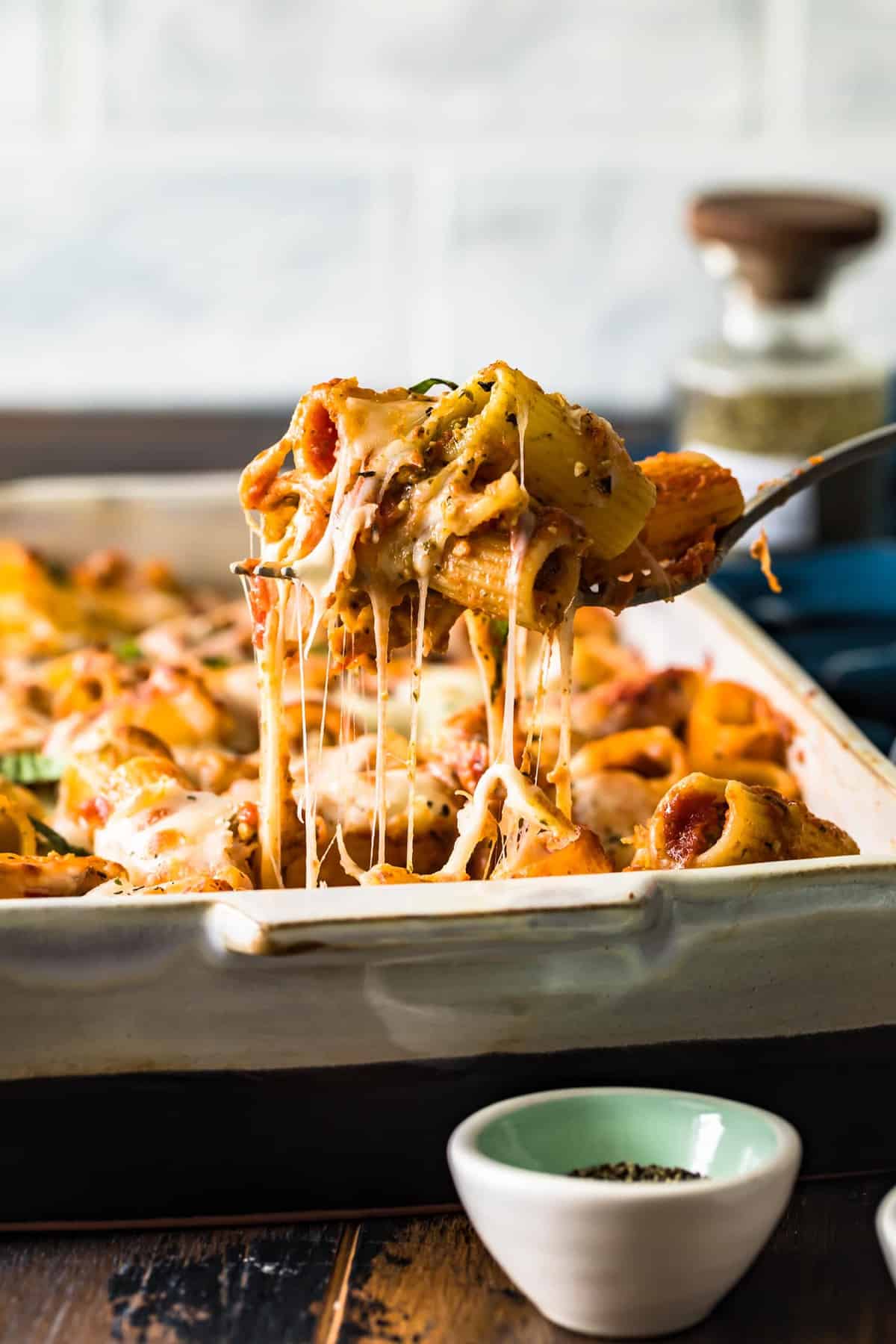 Baked rigatoni lifted out of the dish on a spoon