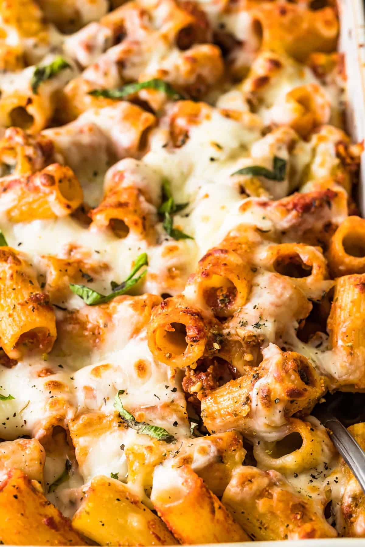 Close up of baked rigatoni with fresh herbs