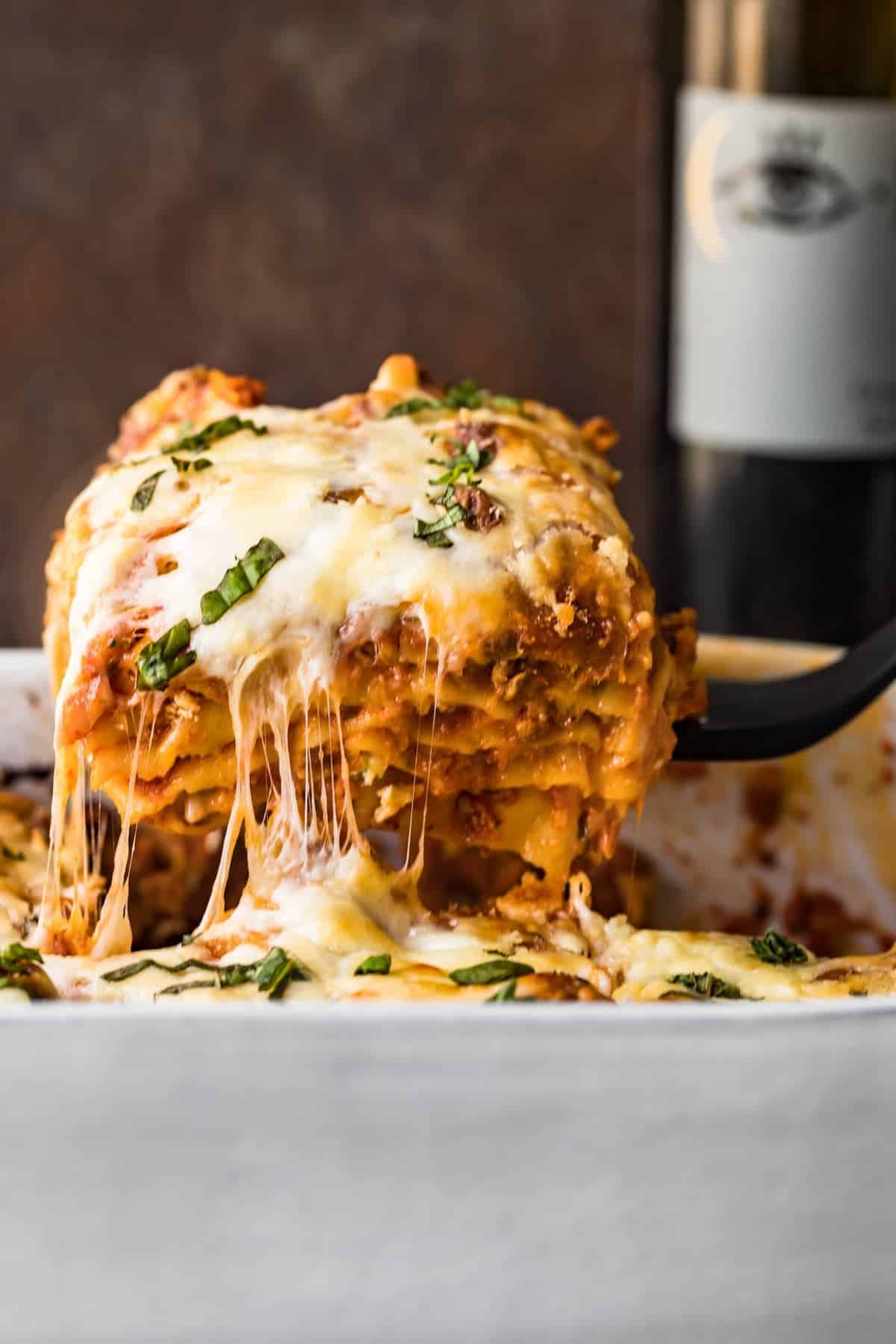  Lasagna with Meat Sauce being lifted out of a white dish