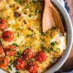 cheesy cauliflower being scooped out of dish