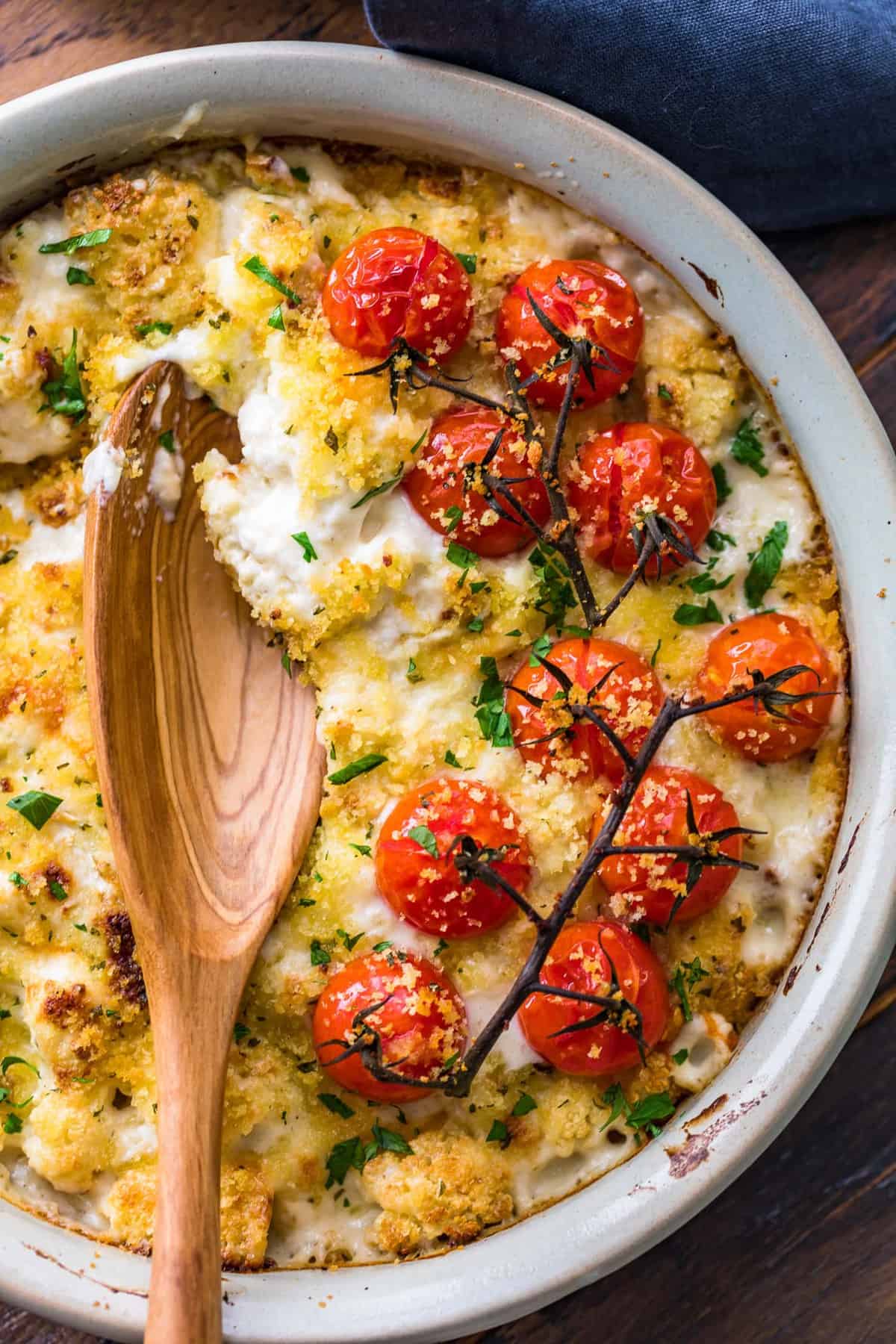 Cauliflower Au Gratin with a wooden spoon in it