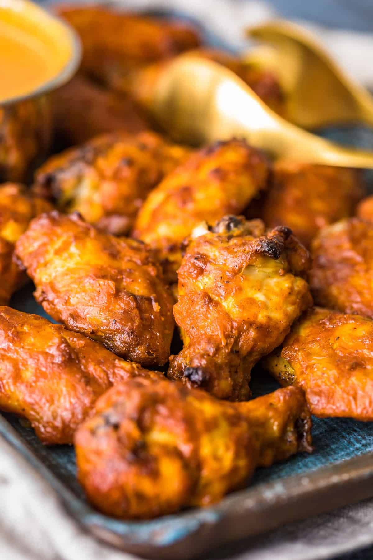 Wings served with sauce on a blue tray